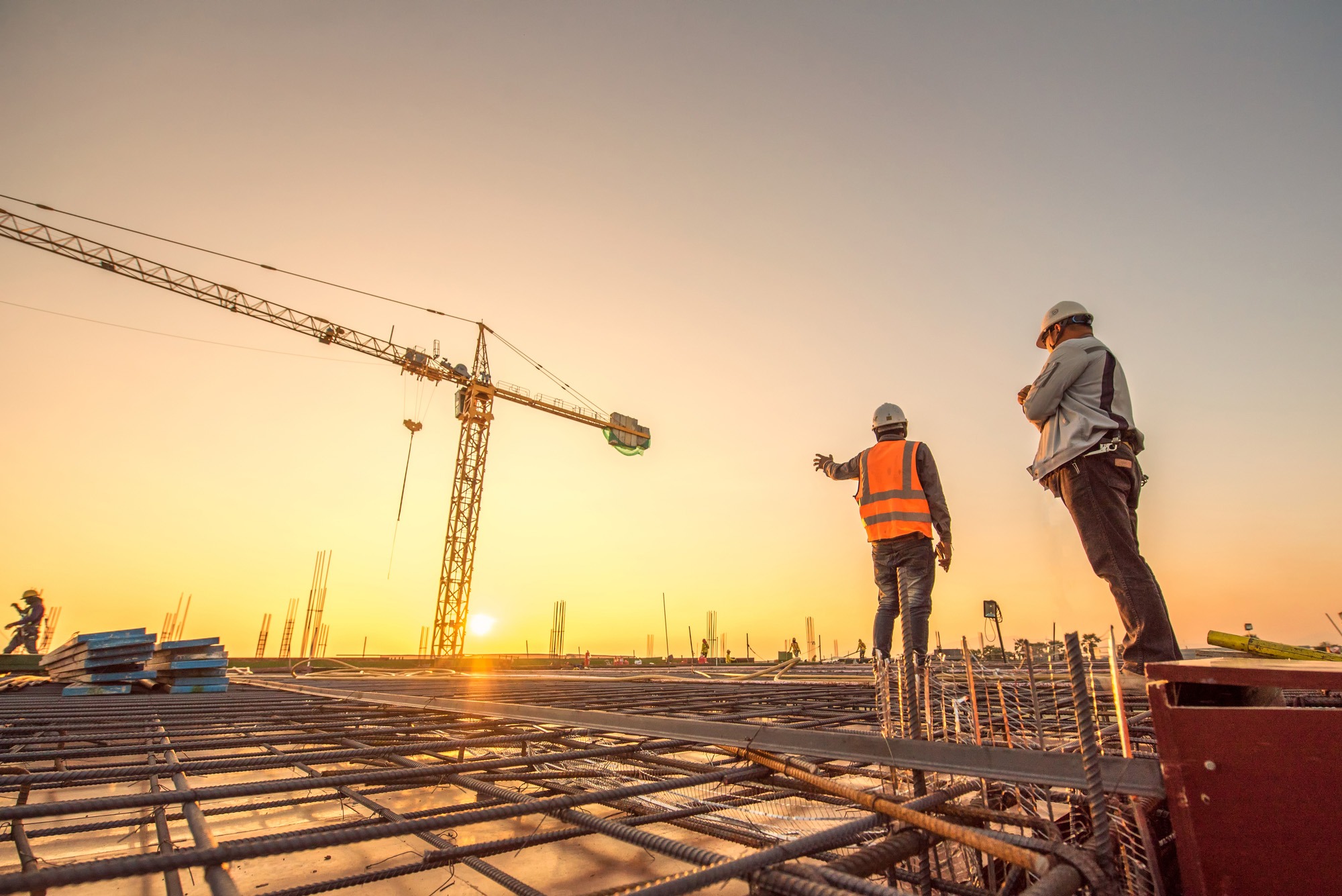 Construction engineers supervising progress of construction project